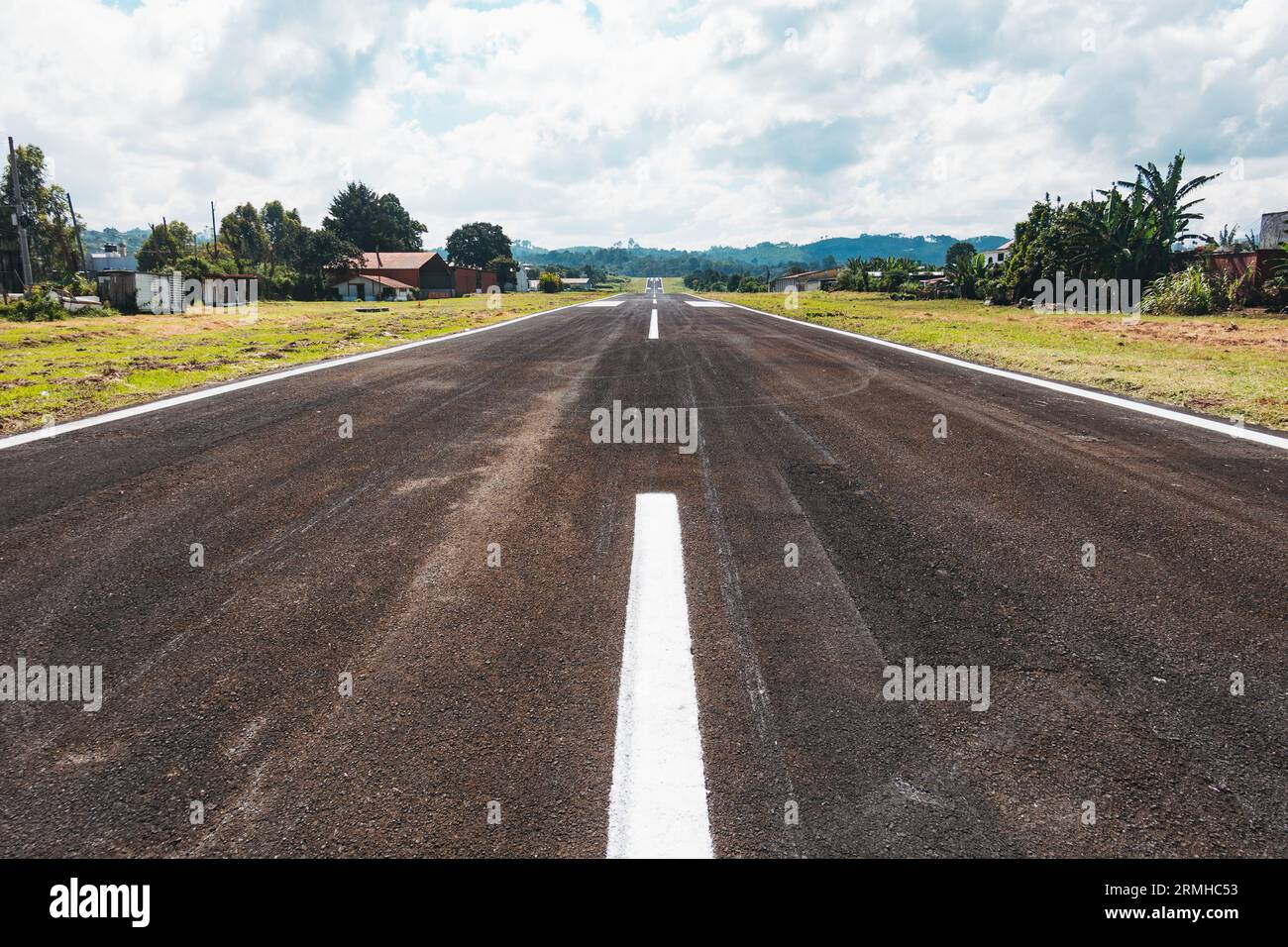 a short, inclined runway with new seal and paint at Cobán Airport, a