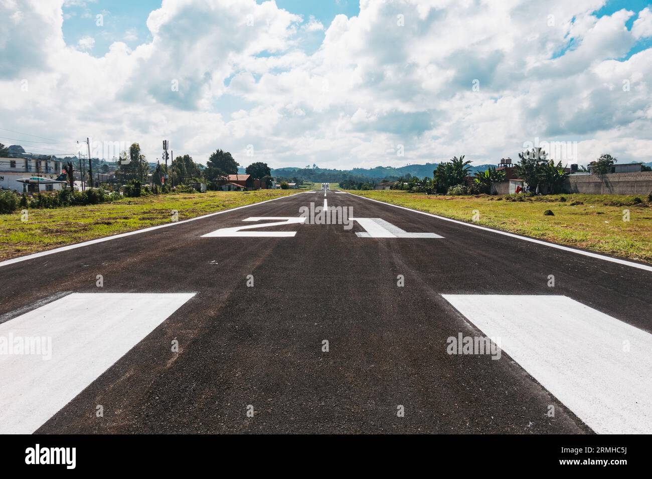 a short, inclined runway with new seal and paint at Cobán Airport, a small aerodrome with a 955 m runway in the Alta Verapaz region of Guatemala Stock Photo