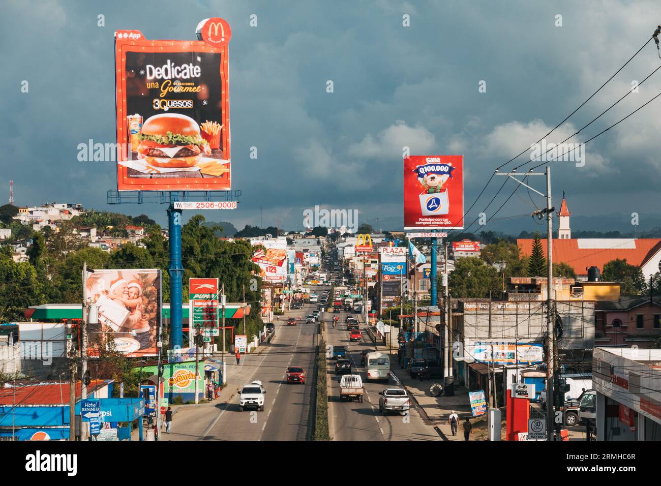 Fast food chains and billboards line the highway of National Route 5 as it passes through the city of Cobán, Central Guatemala Stock Photo