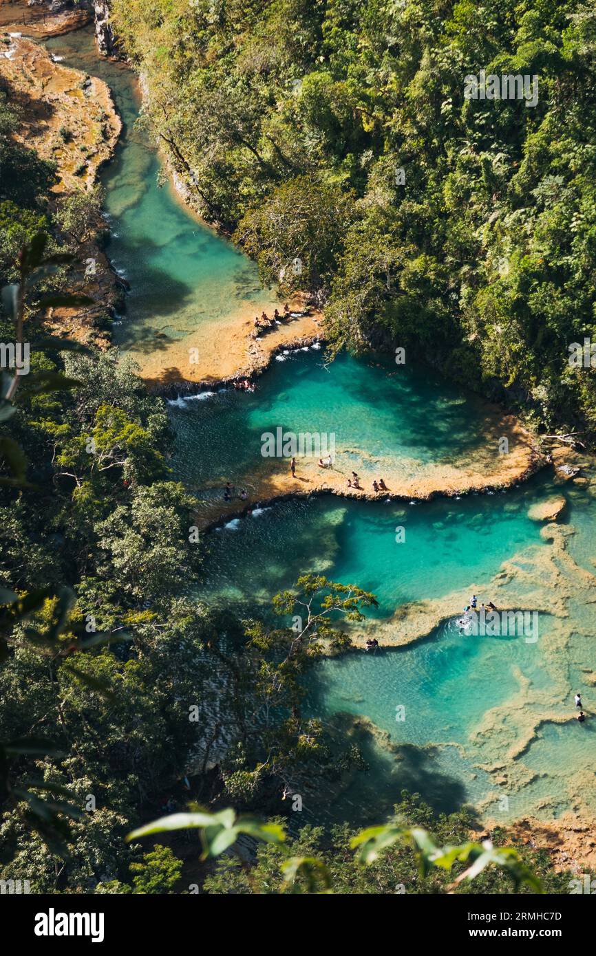 Tourists swim and enjoy the turquoise pools on the Cahabón River in Semuc Champey Natural Monument, Guatemala Stock Photo