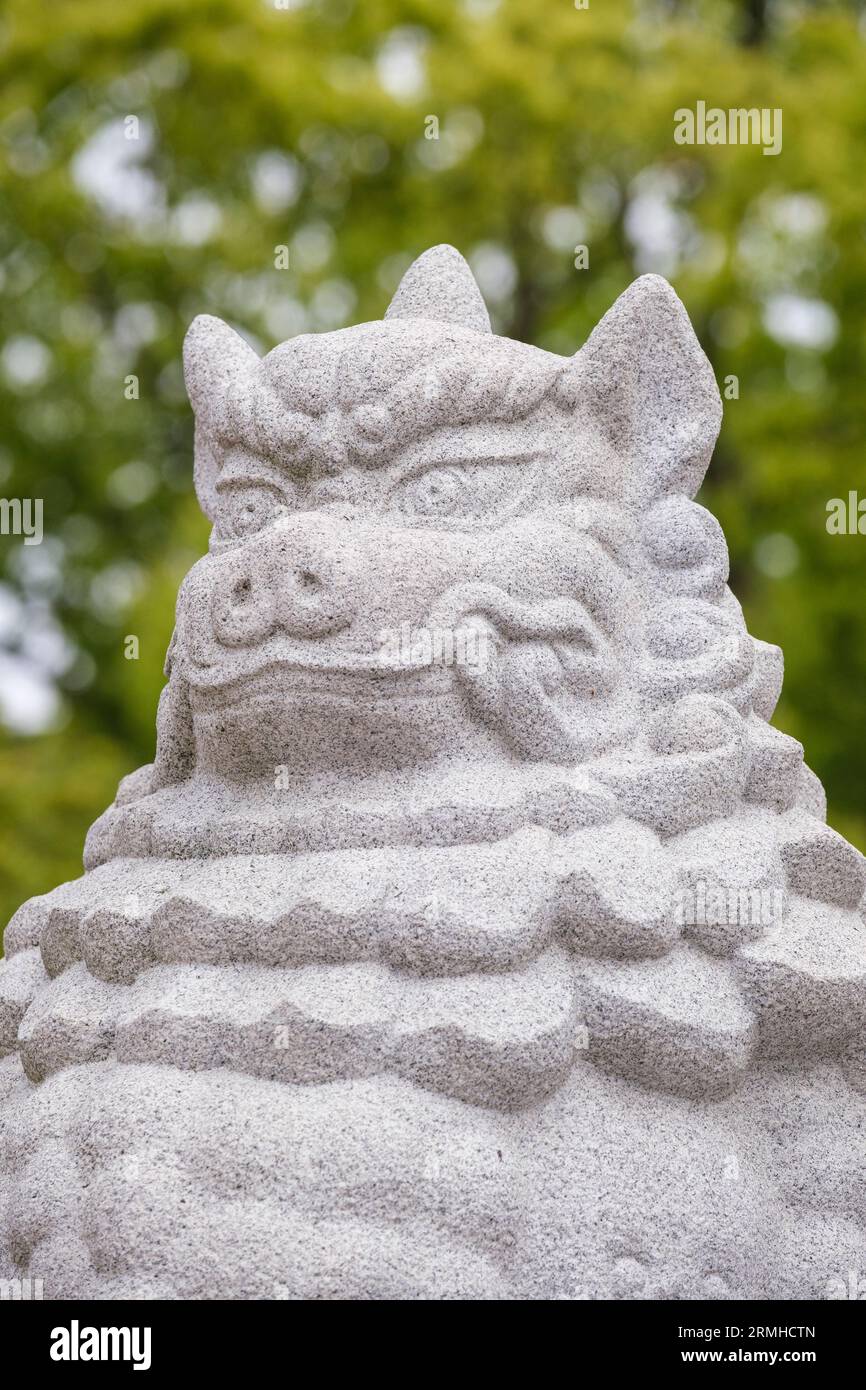 Japan, Kyushu, Fukuoka, Hakata. Toka-Ebisu Shinto Shrine. Lion-dog Guardian with Mouth Closed Signifying Last Sound Made at Death. Stock Photo