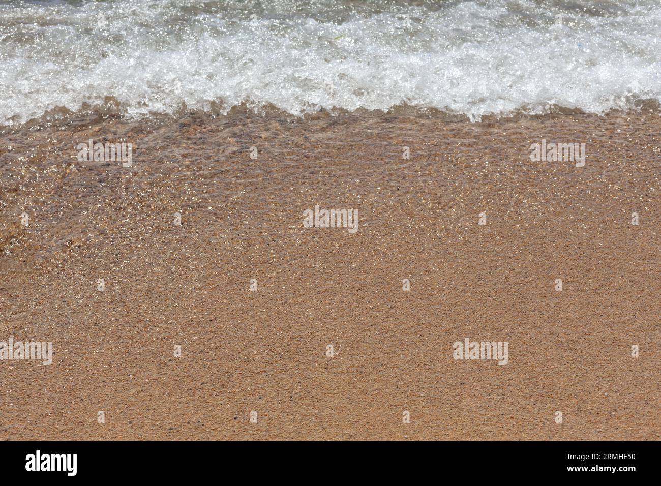 Soft Ocean Wave on Sandy Beach Stock Photo
