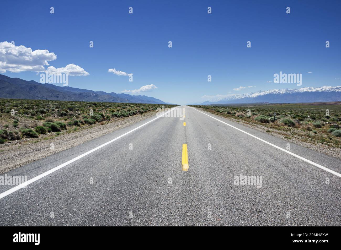 an empty highway 6 heading south between the White Mountains and the Sierra Nevada in Eastern California Stock Photo