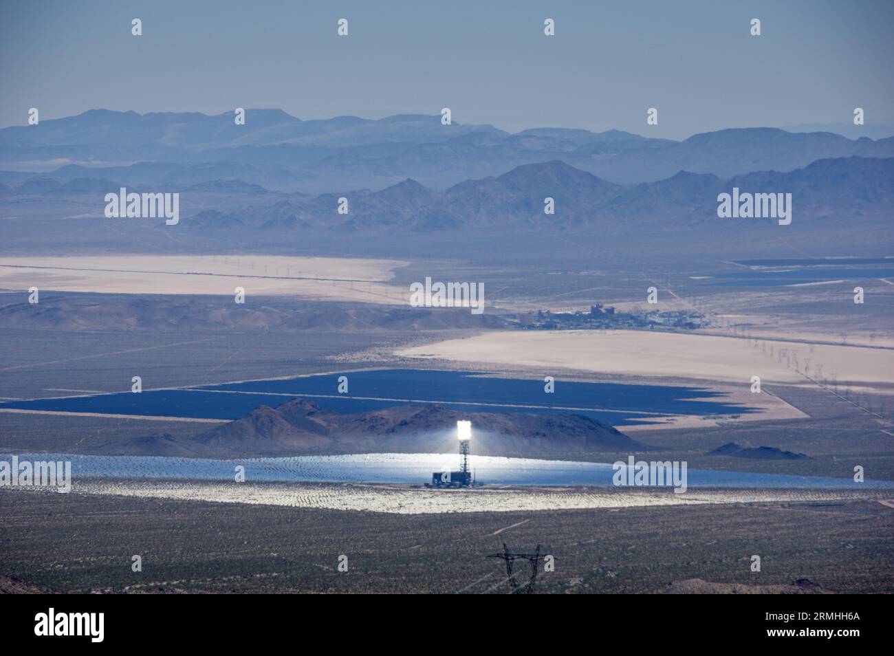 Mojave Desert solar power plants including one of the Ivanpah thermal solar towers and mirror array and photovoltaic panels and Primm Nevada Stock Photo