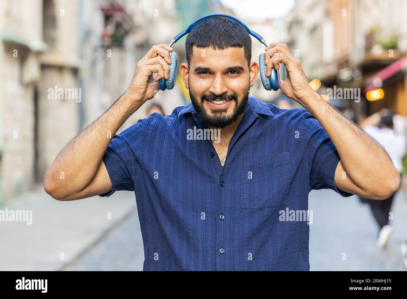 Profile of happy overjoyed indian young man wearing wireless headphones ...