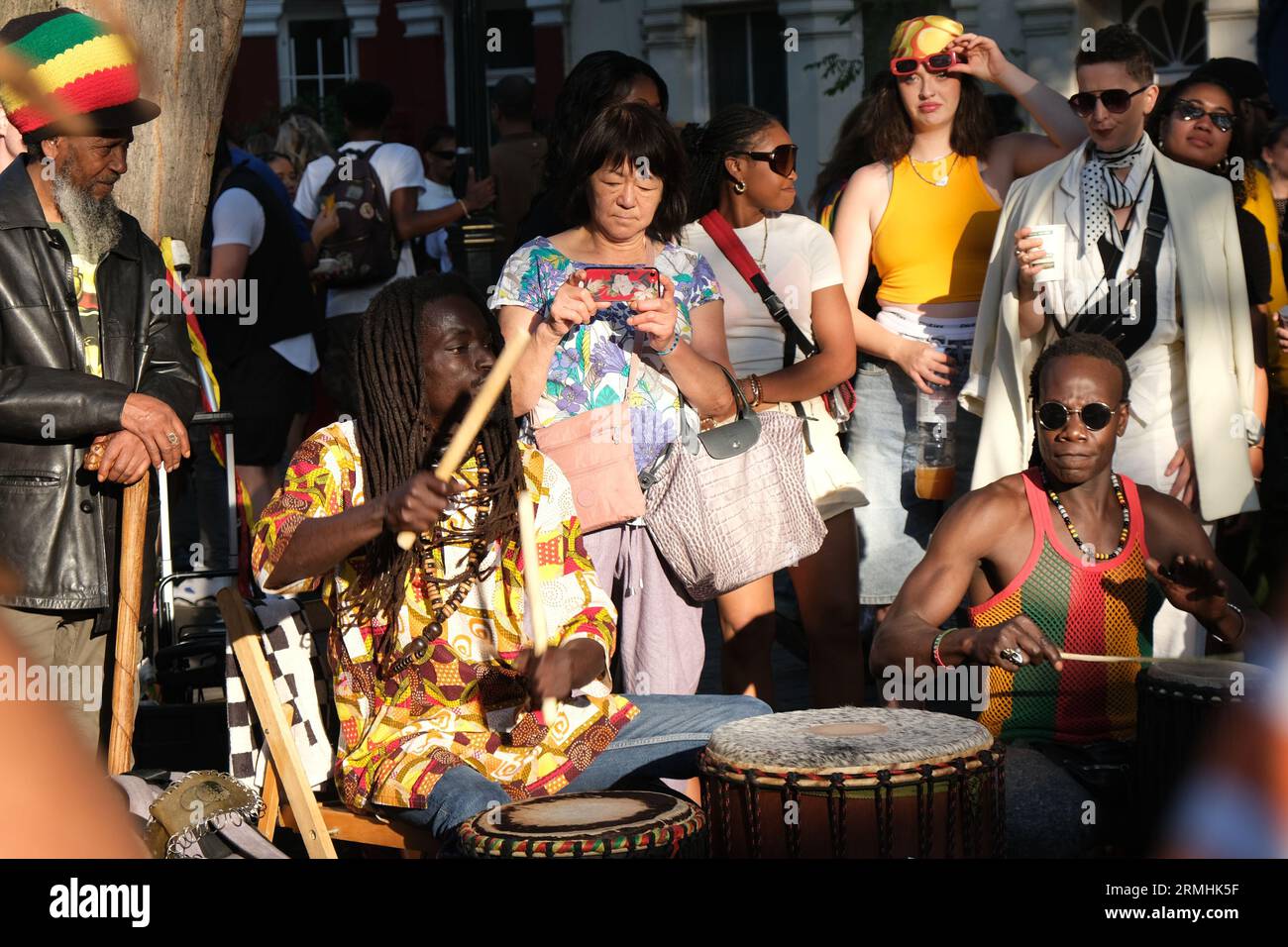 Men drum energetically on the Portobello Road during the Notting Hill Carnival celebration of Caribbean culture. 28/08/2023 Stock Photo