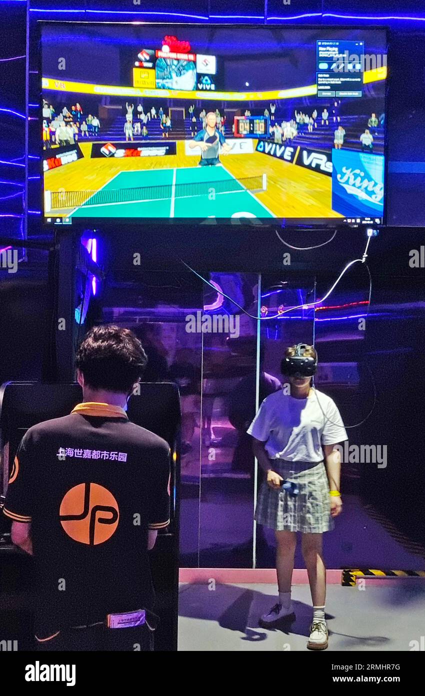 SHANGHAI, CHINA AUGUST 28, 2023 Parents play an AI table tennis