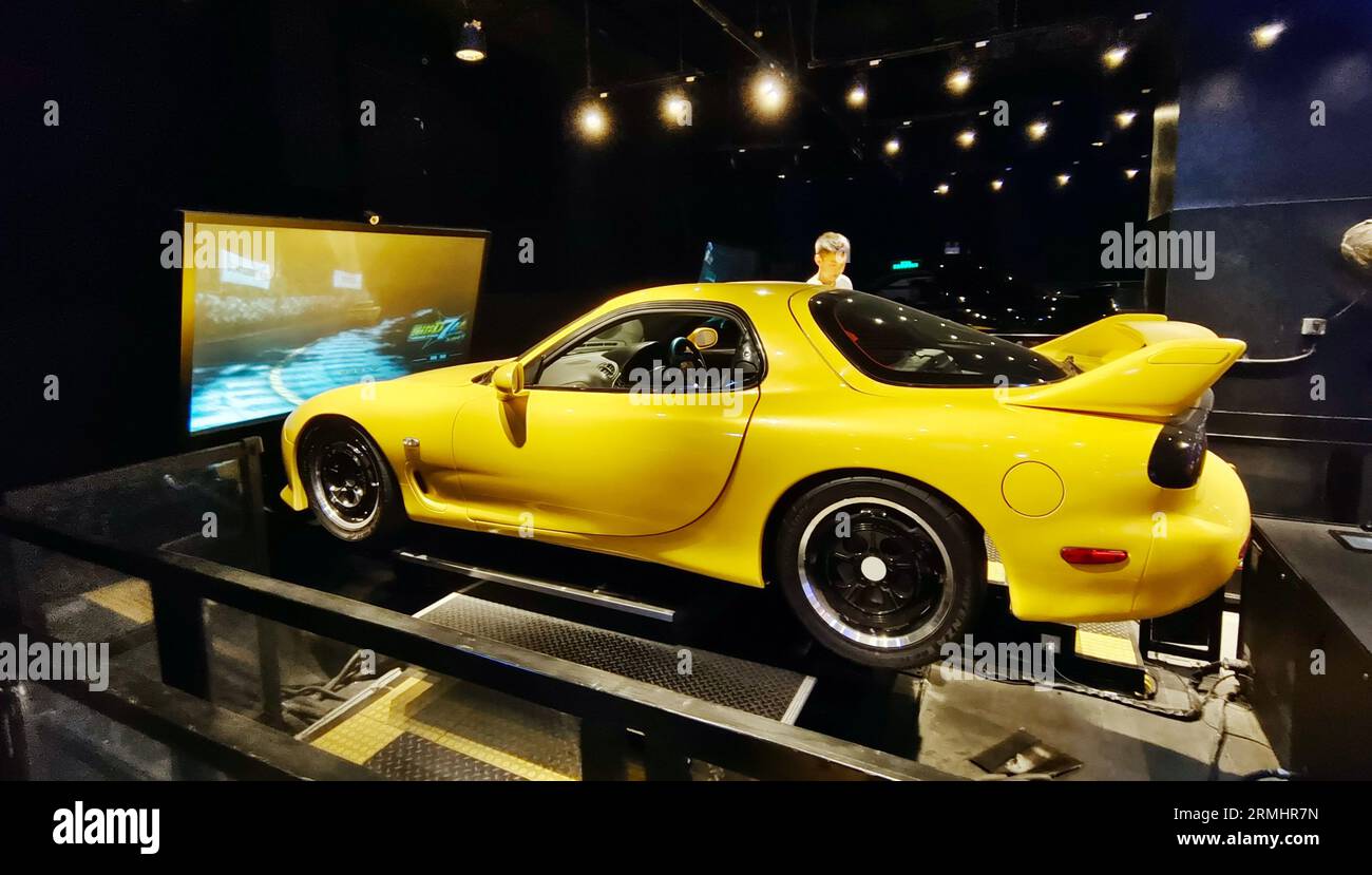 SHANGHAI, CHINA AUGUST 28, 2023 Parents play a VR racing game with