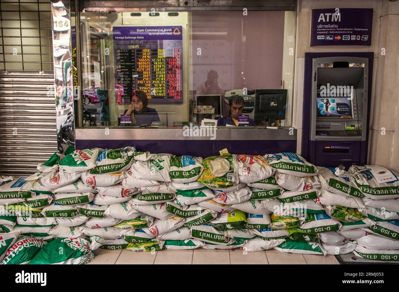 The climate crisis. A currency exchange booth prepares for the flood with sandbags. Bangkok, Thailand. Oct., 2011. © Kraig Lieb Stock Photo