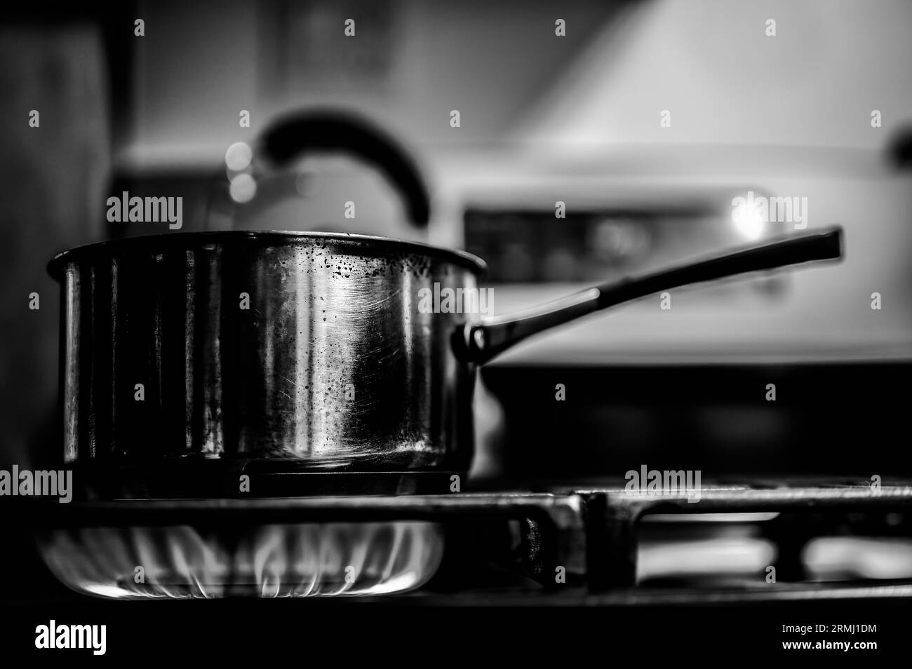 Natural gas burner at a cabin kitchen heating up a metal pot Stock