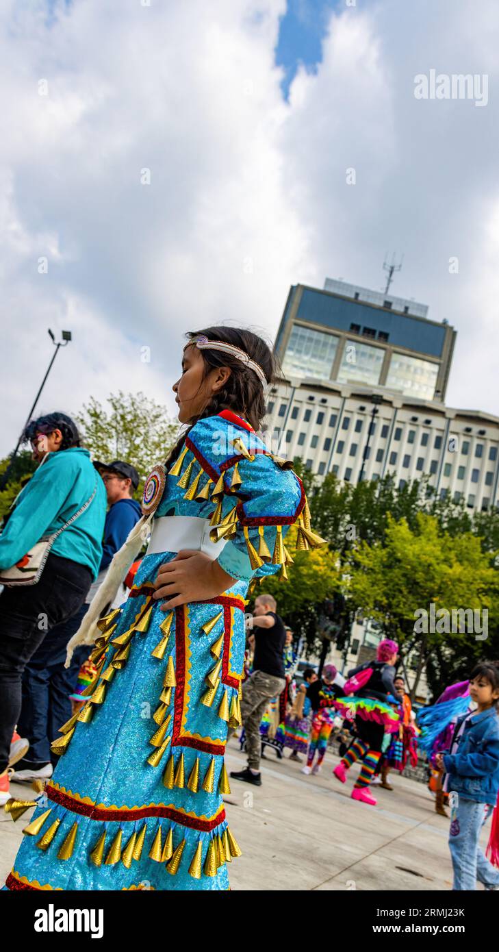 Edmonton, Alberta, Canada. 22nd Aug, 2023. A young participant wearing a traditional Jingle dress participates during the event. As Pride weekend kicks off in Edmonton, the Indigenous Community recognizes the event with the 2 Spirit Powwow. The term Two-Spirit is a direct translation of the Ojibwe term, Niizh manidoowag. "Two-Spirited"" or "Two-Spirit"" is usually used to indicate a person whose body simultaneously houses a masculine spirit and a feminine spirit. A part of the celebration is the inclusiveness of all and welcoming everyone to celebrate by competing in a jig dance. All at Stock Photo