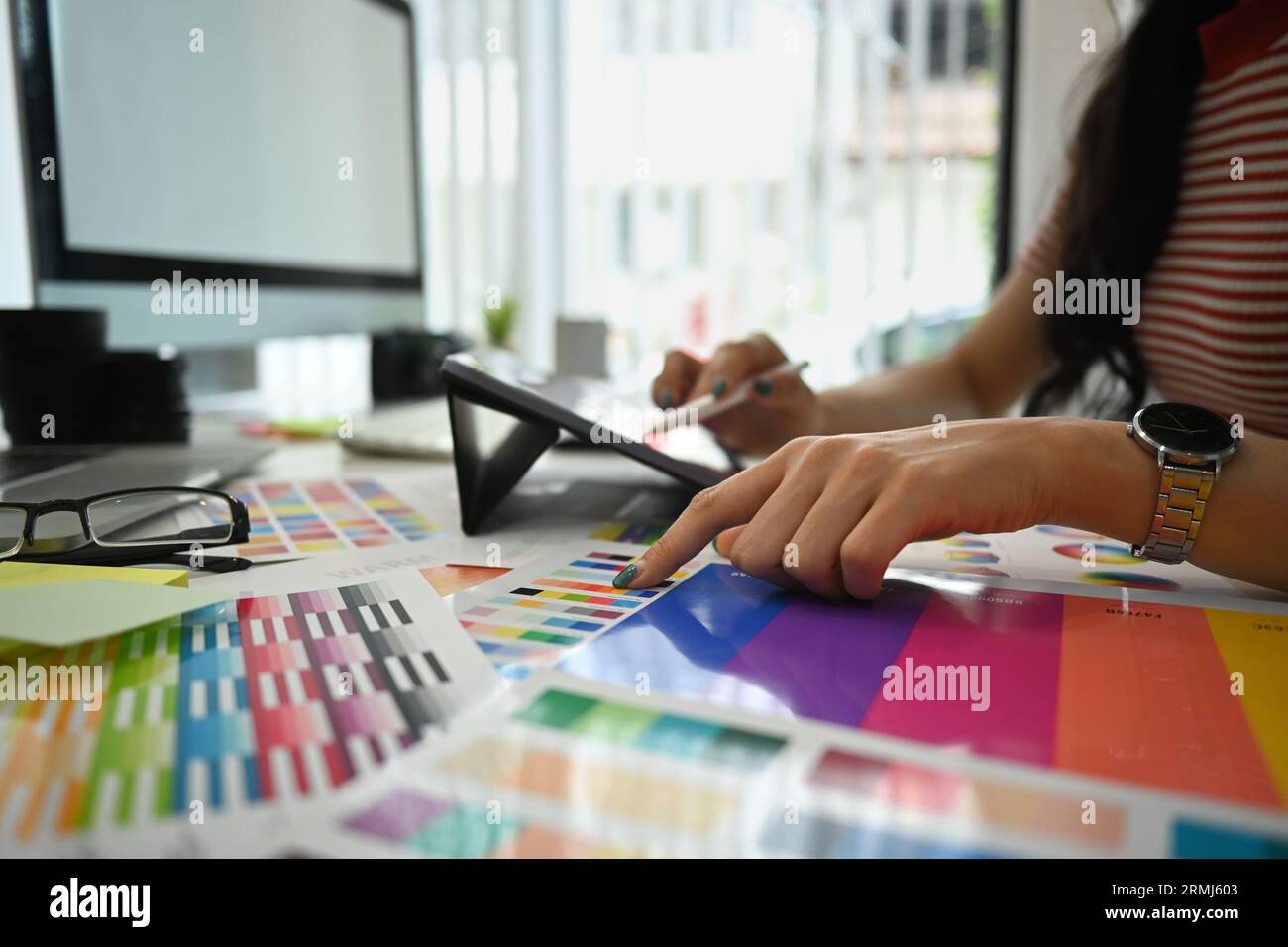 Working With Color Closeup view female designer working with color palette, choosing color ...