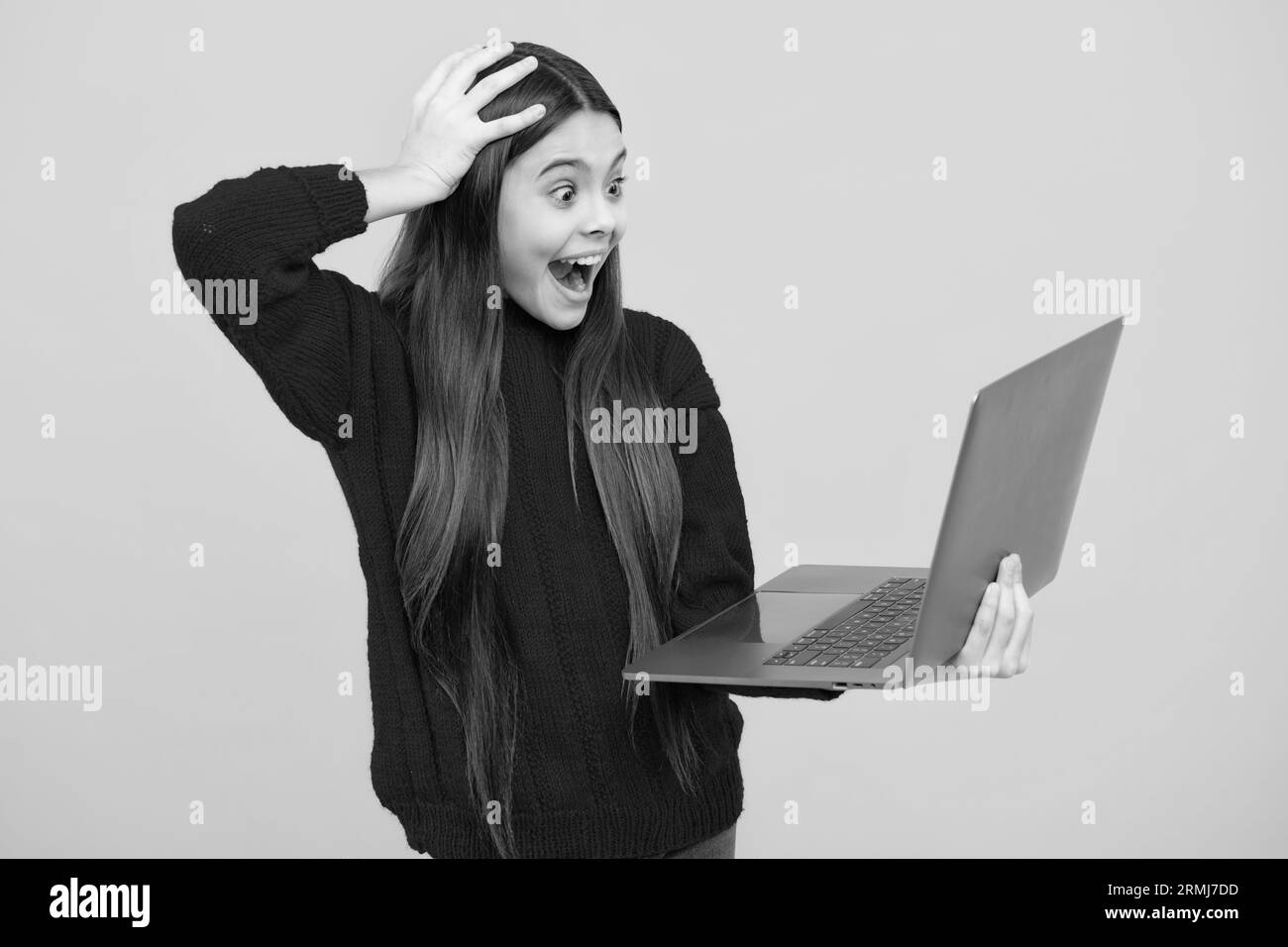 Reading Computer Amazed Excited face. Back to school, Teenager school girl with laptop computer ...