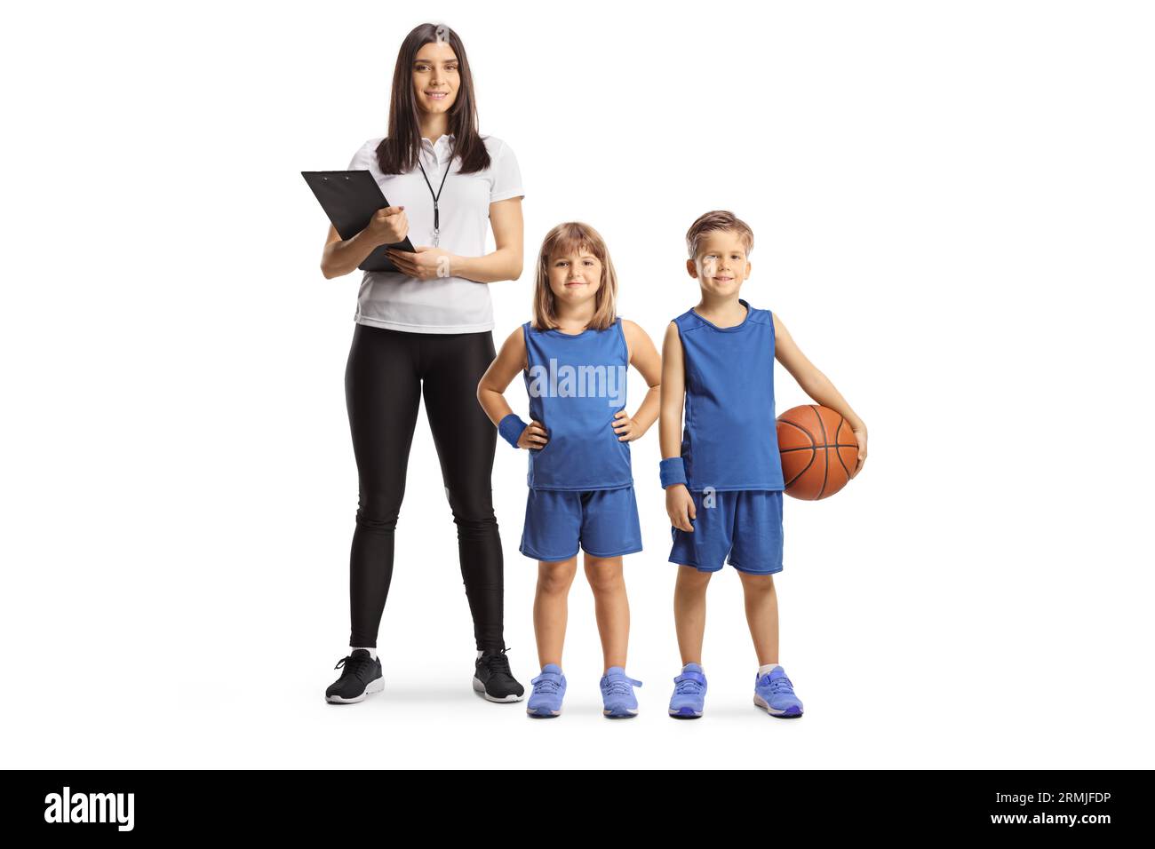 Female basketball coach standing with children in sport jerseys isolated on white background Stock Photo