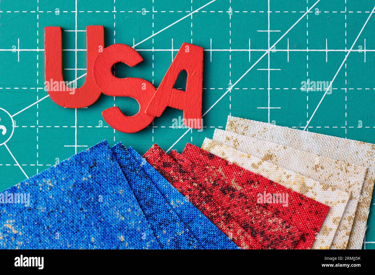 Wooden letters consisting to the abbreviation USA and square pieces of fabric in the US flag