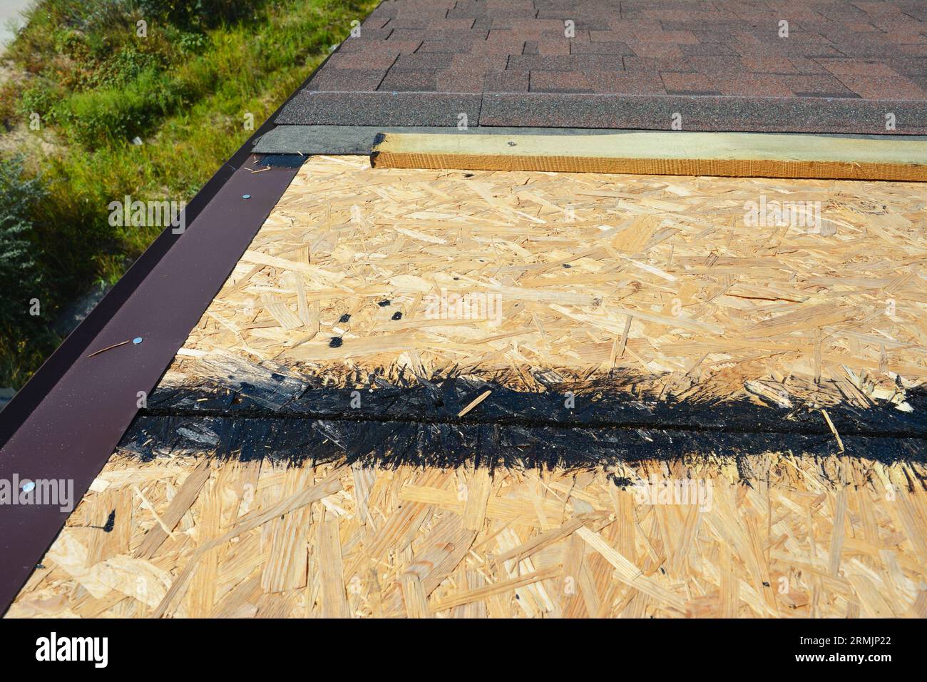 Installing asphalt roof shingles on the underlayment of the house