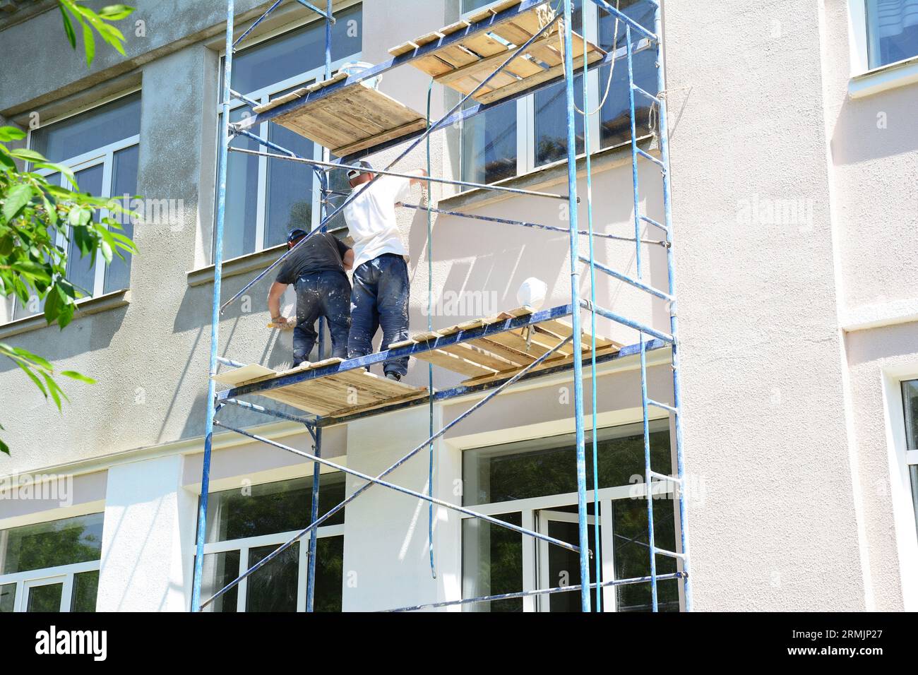 Painting house walls. Builder contractors repair and painting external