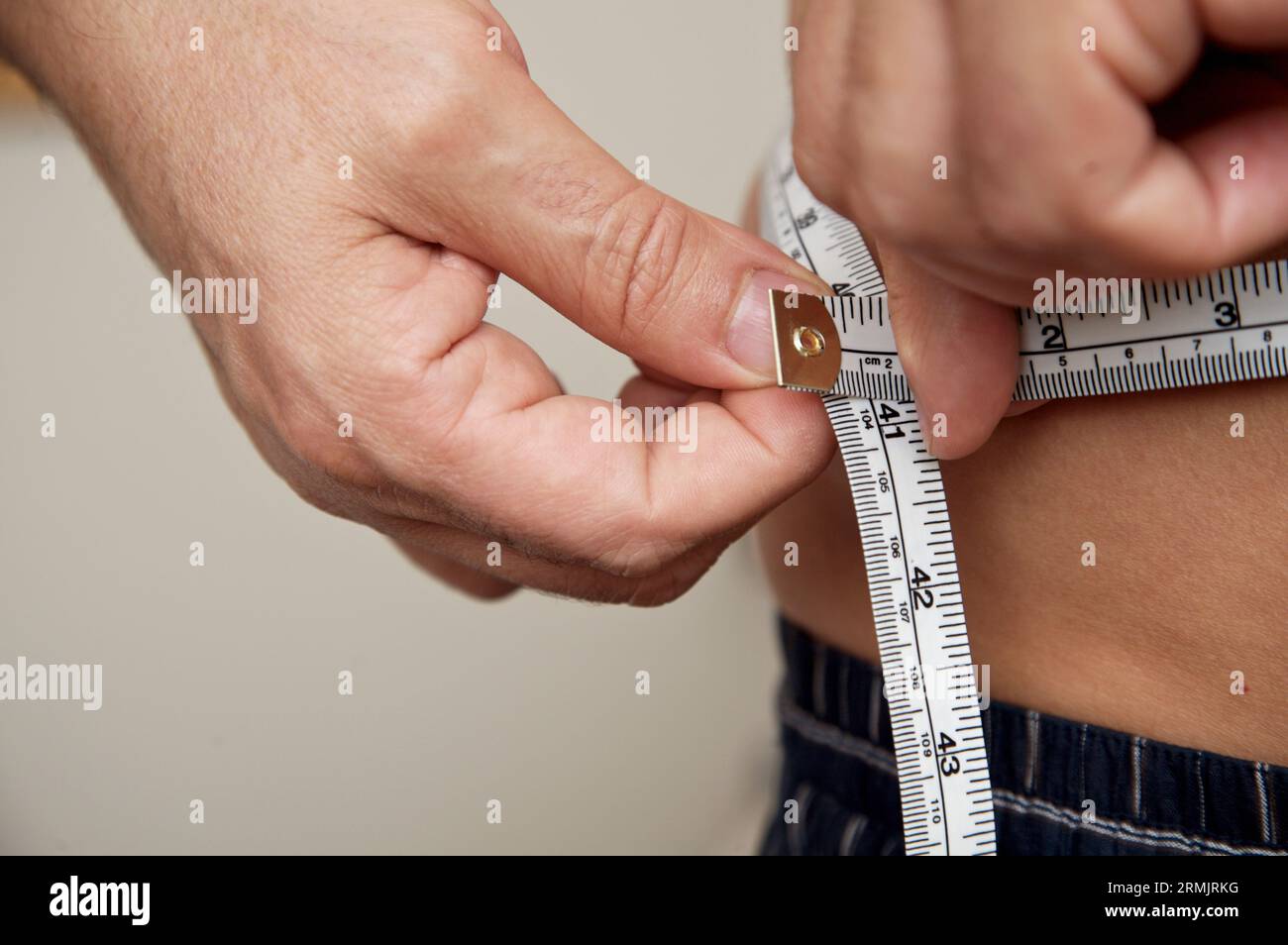 Close-up of a man measuring his biceps with a tape measure Stock Photo -  Alamy