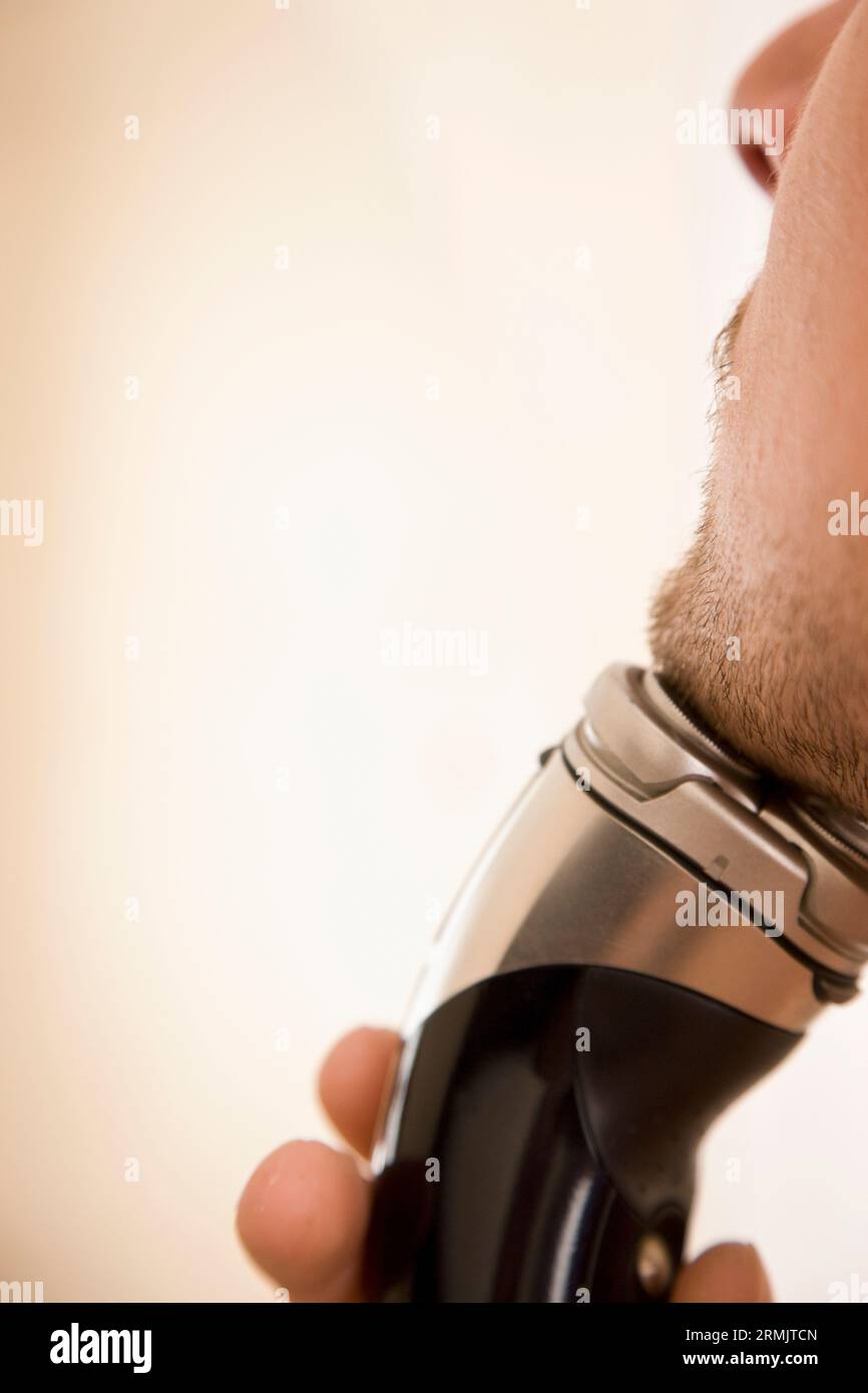 Man holding electric shaver hi-res stock photography and images - Alamy