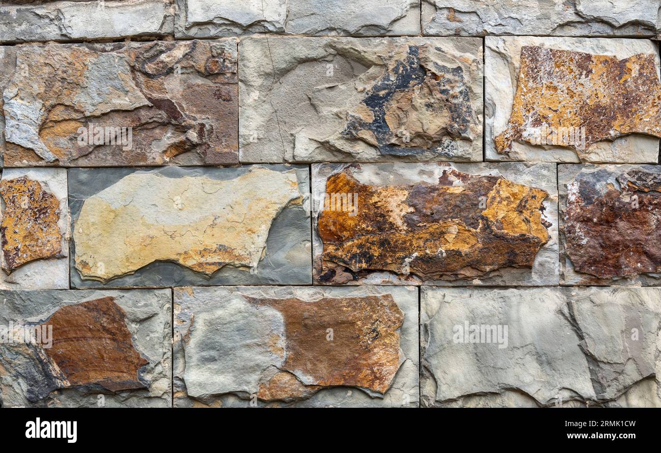 Textured crude stone wall close-up Stock Photo