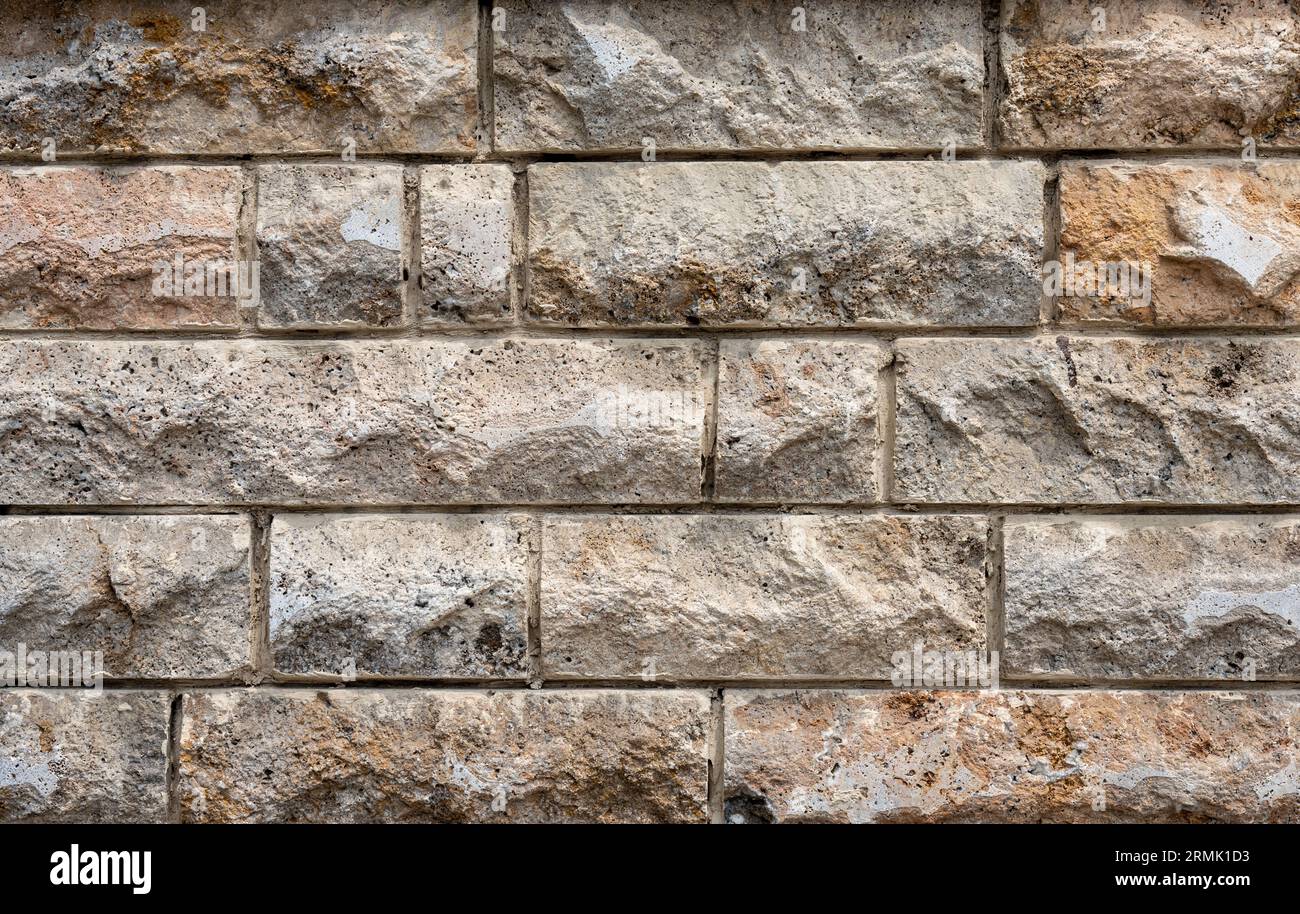 Textured crude stone wall close-up Stock Photo