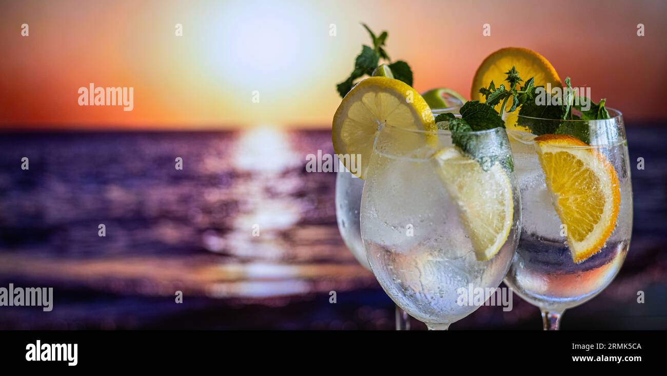 Three Colorful Gin Tonic Cocktails In Glasses On The Bar Counter In Pub Or Restaurant. Night Pub By The Sea. Lifestyle Stock Photo