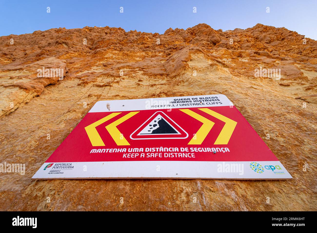 ROCKFALL UNSTABLE CLIFFS, KEEP A SAFE DISTANCE is written in English on ...