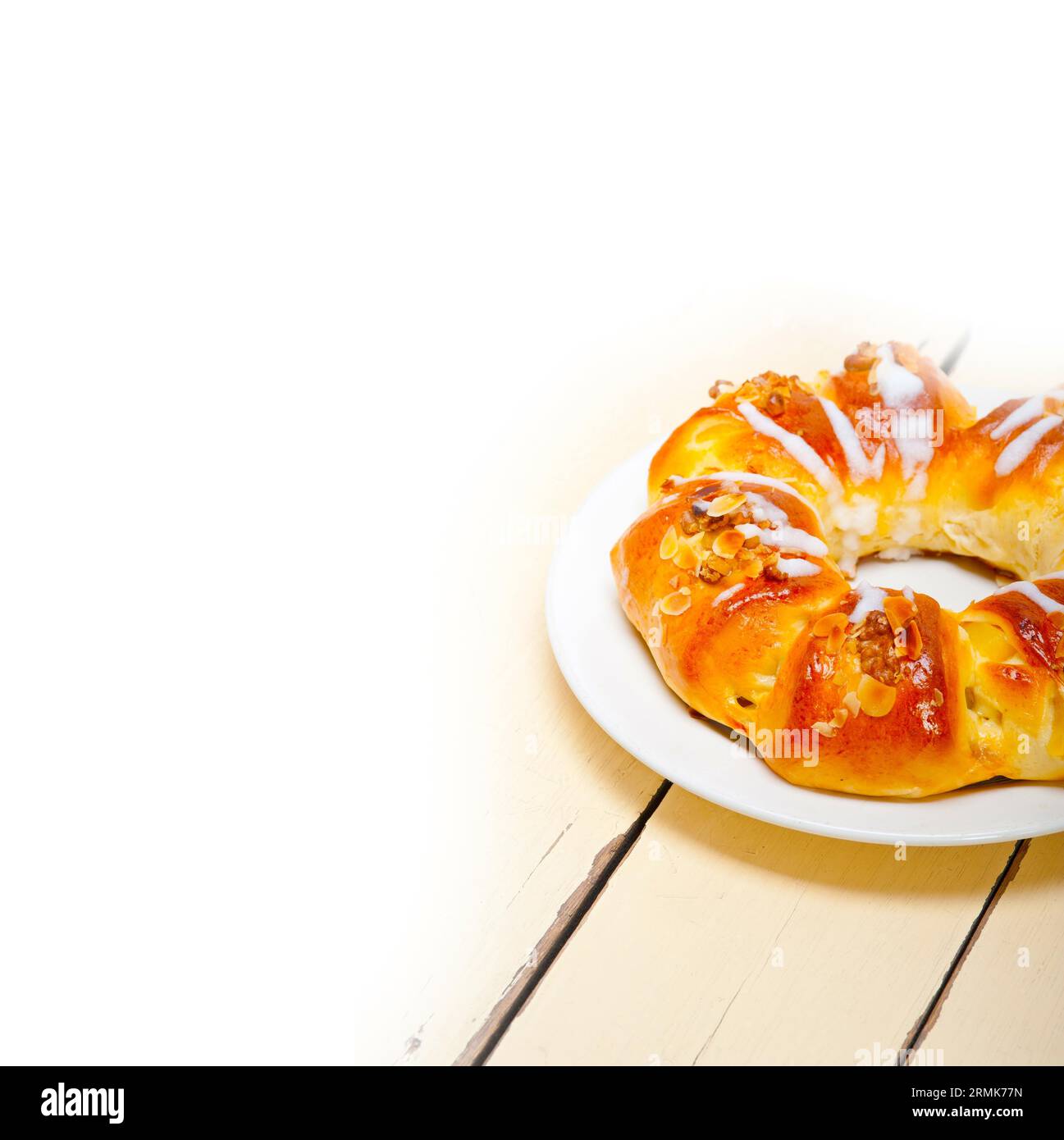 Fresh home baked sweet bread donut cake with almonds and icing sugar on