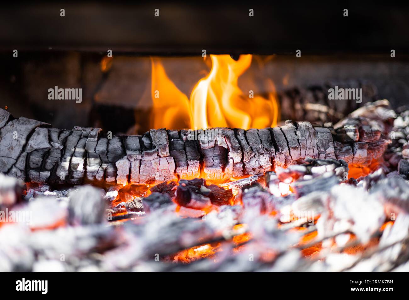 Barbecue grill pit with hot coals. Glowing and flaming charcoal briquettes for fire BBQ. Stock Photo