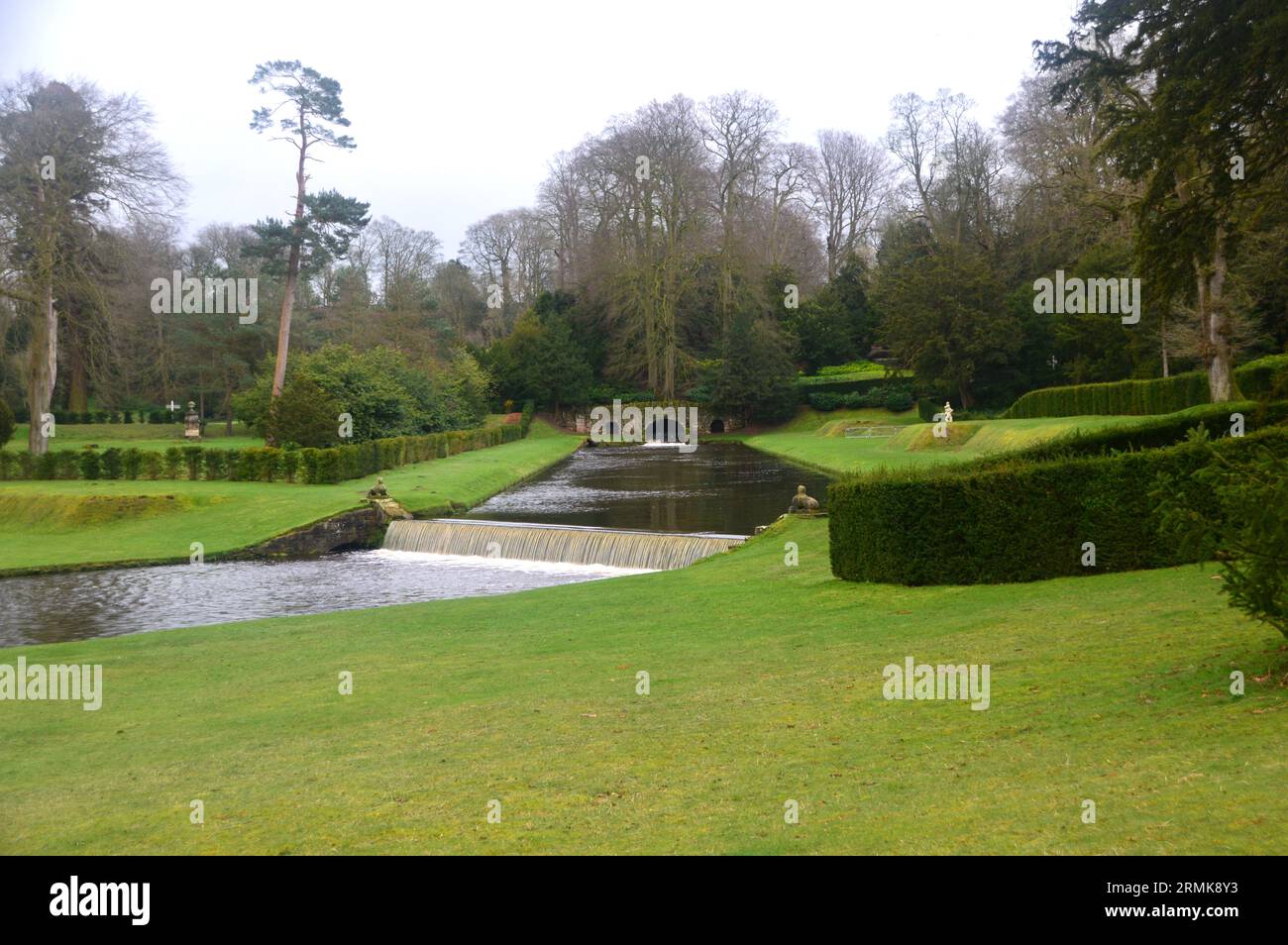 The Upper Canal, Rustic Bridge and Drum Falls on the River Skell at Fountains Abbey and Studley Royal Water Garden, North Yorkshire, England, UK. Stock Photo