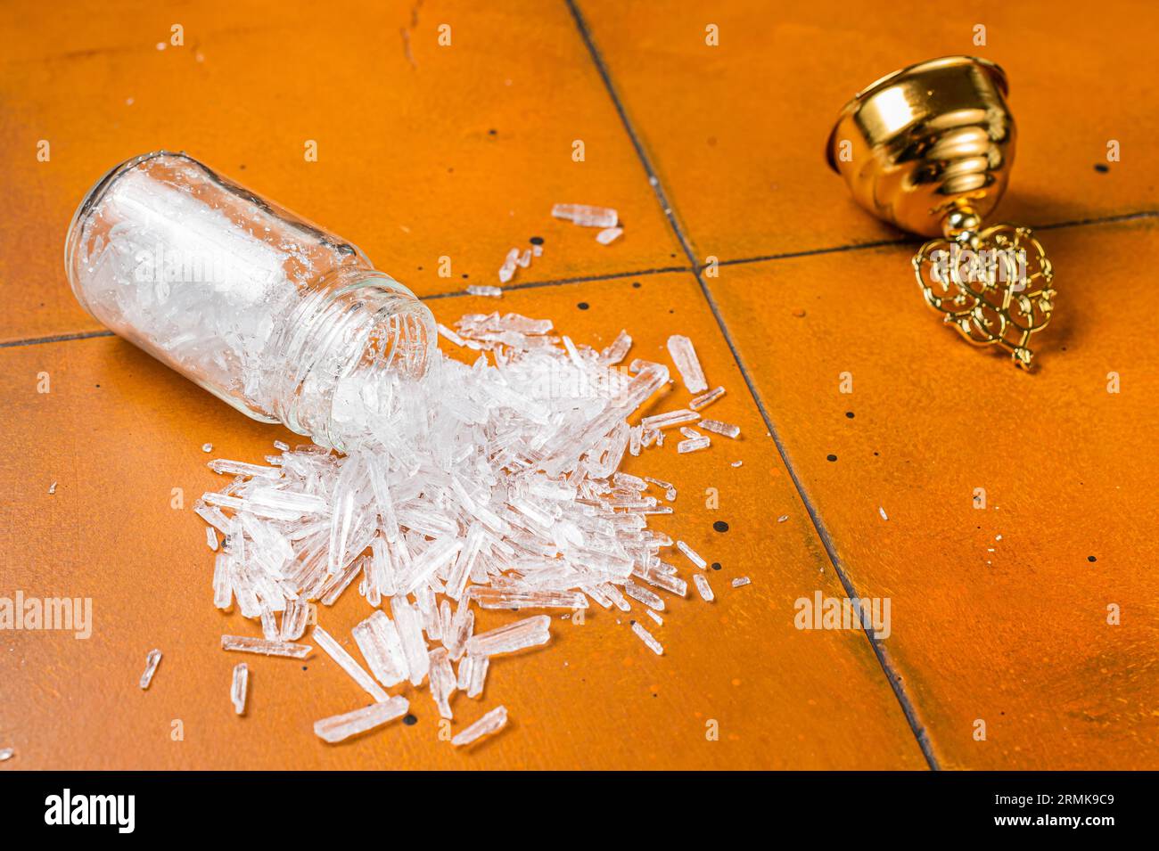 Natural Menthol Crystals, Ingredients for production of natural cosmetics. Orange background. Top view. Stock Photo