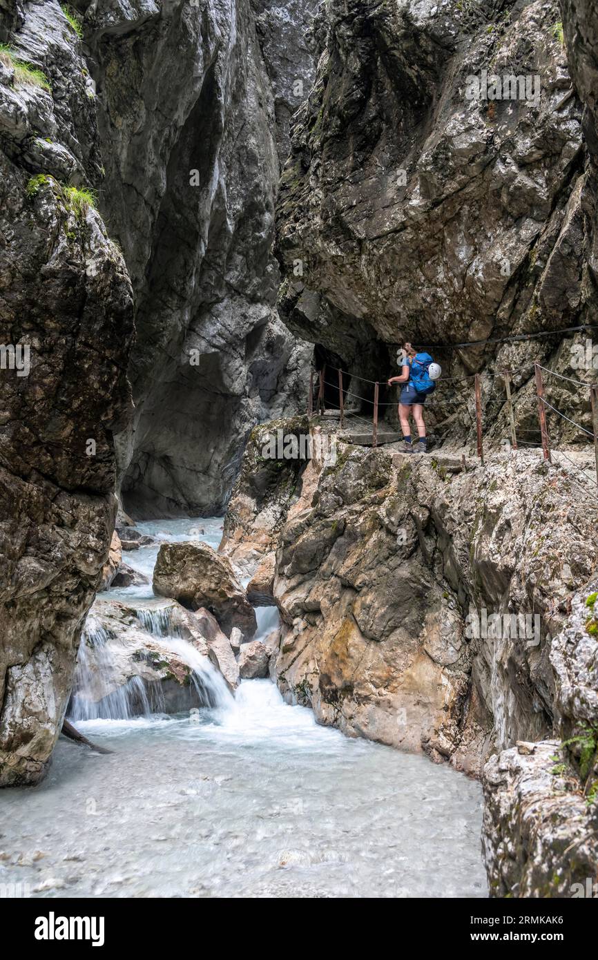 Hiker in a gorge, Hammersbach flows through Hoellentalklamm, near Garmisch-Partenkirchen, Werdenfelser Land, Upper Bavaria, Bavaria, Germany Stock Photo