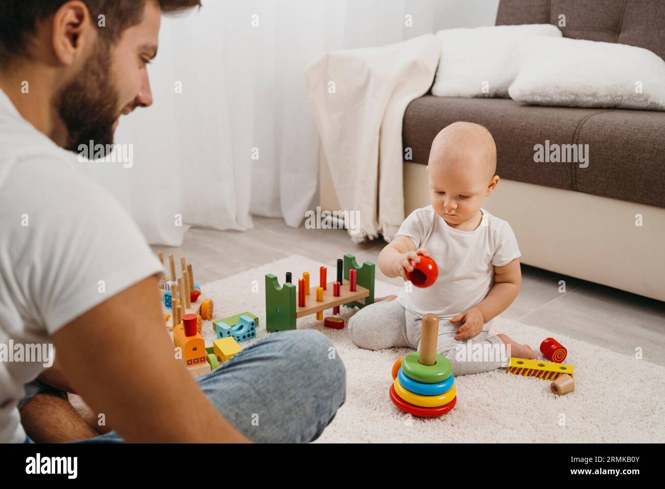 Baby home playing with his father Stock Photo