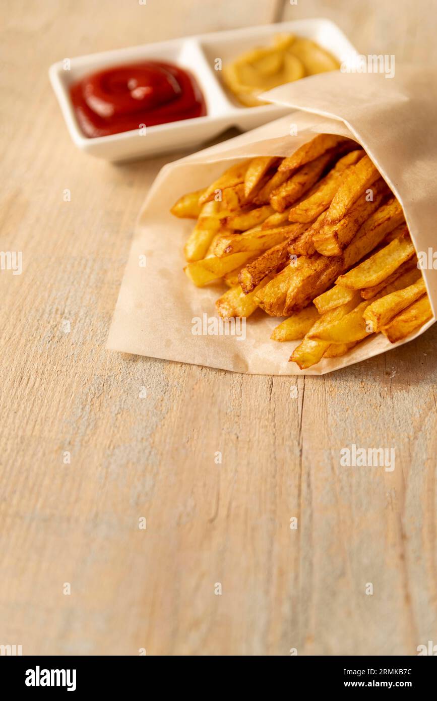 Close up french fries with wooden background Stock Photo