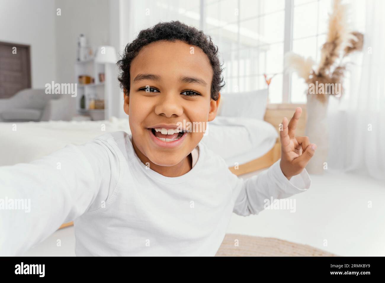 Front view little boy taking selfie home Stock Photo