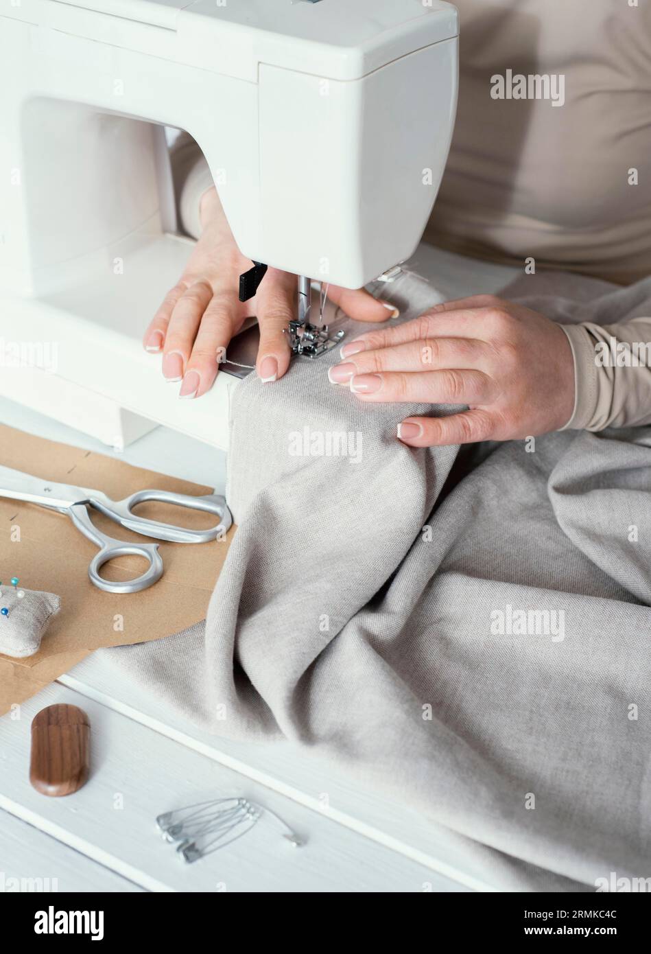 High angle seamstress using sewing machine Stock Photo