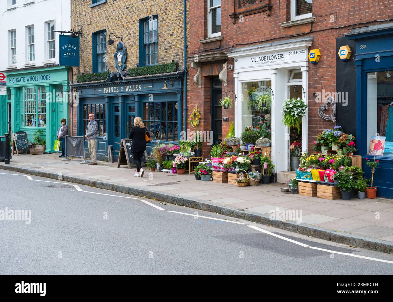 Colourful Georgian shops with pavement displays on Highgate High Street, Highgate Village, London, England, UK Stock Photo