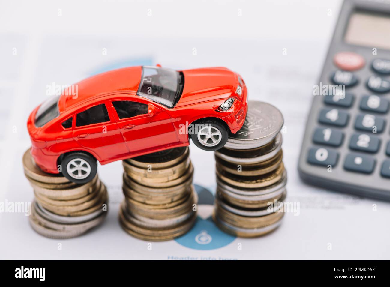 Toy car balancing increasing coin stack Stock Photo