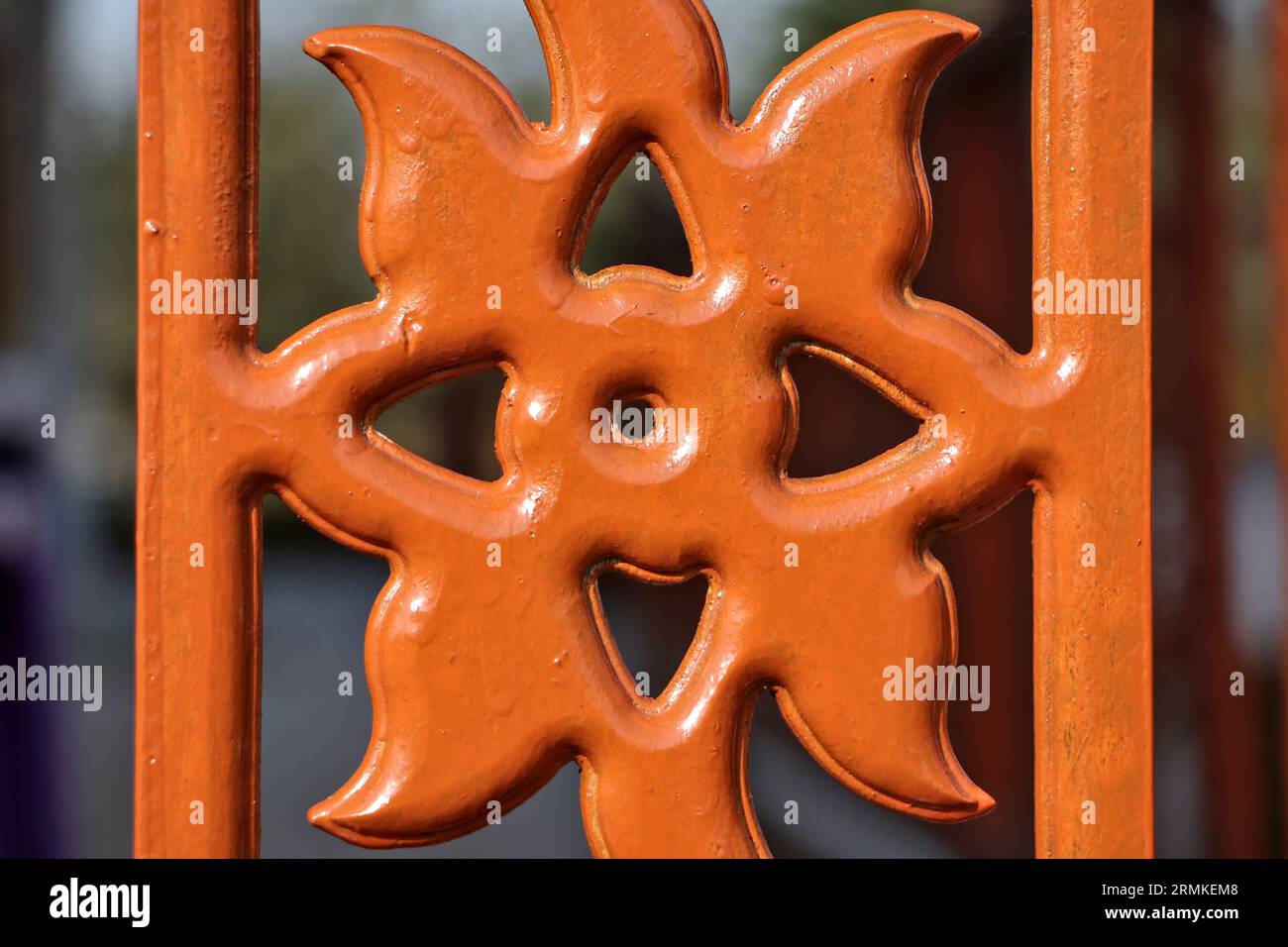 Close up of a wooden fence carved with a simple floral pattern. Stock Photo