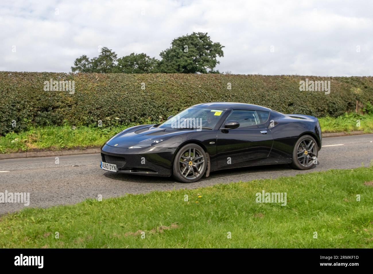 2010 Lotus Evora 4 V6 Black Car Coupe Petrol 3456 cc, supercharged and intercooled DOHC 24-valve V-6,  equipped with a mid-mounted, transverse, Toyota-sourced 3.5-litre 24-valve 2GR V6 engine. Stock Photo
