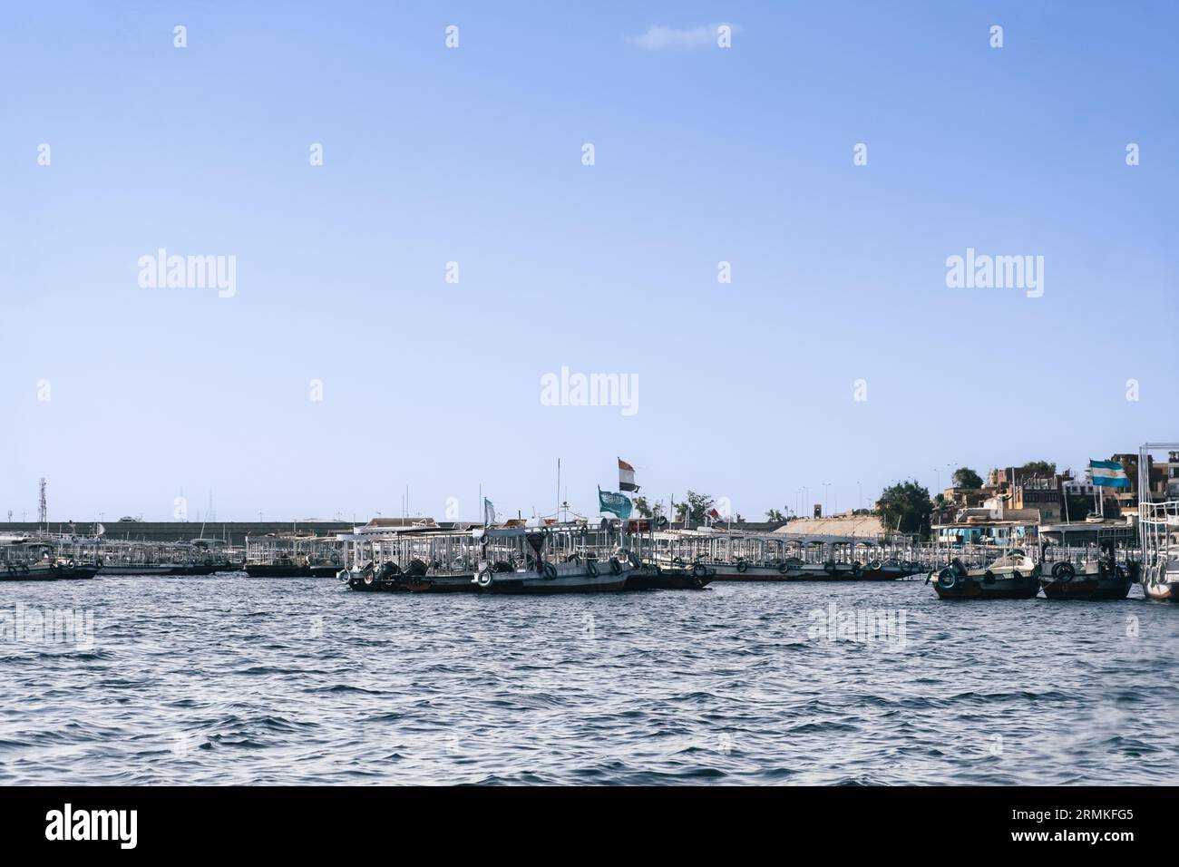 Egypt Summer Travel Tranquil Waterside Haven: Boats in a Nile River Village Stock Photo