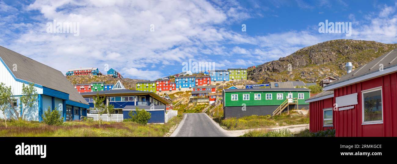 Typical architecture of Greenland city Qarqotoq with colored houses located near fjords and icebergs. Stock Photo