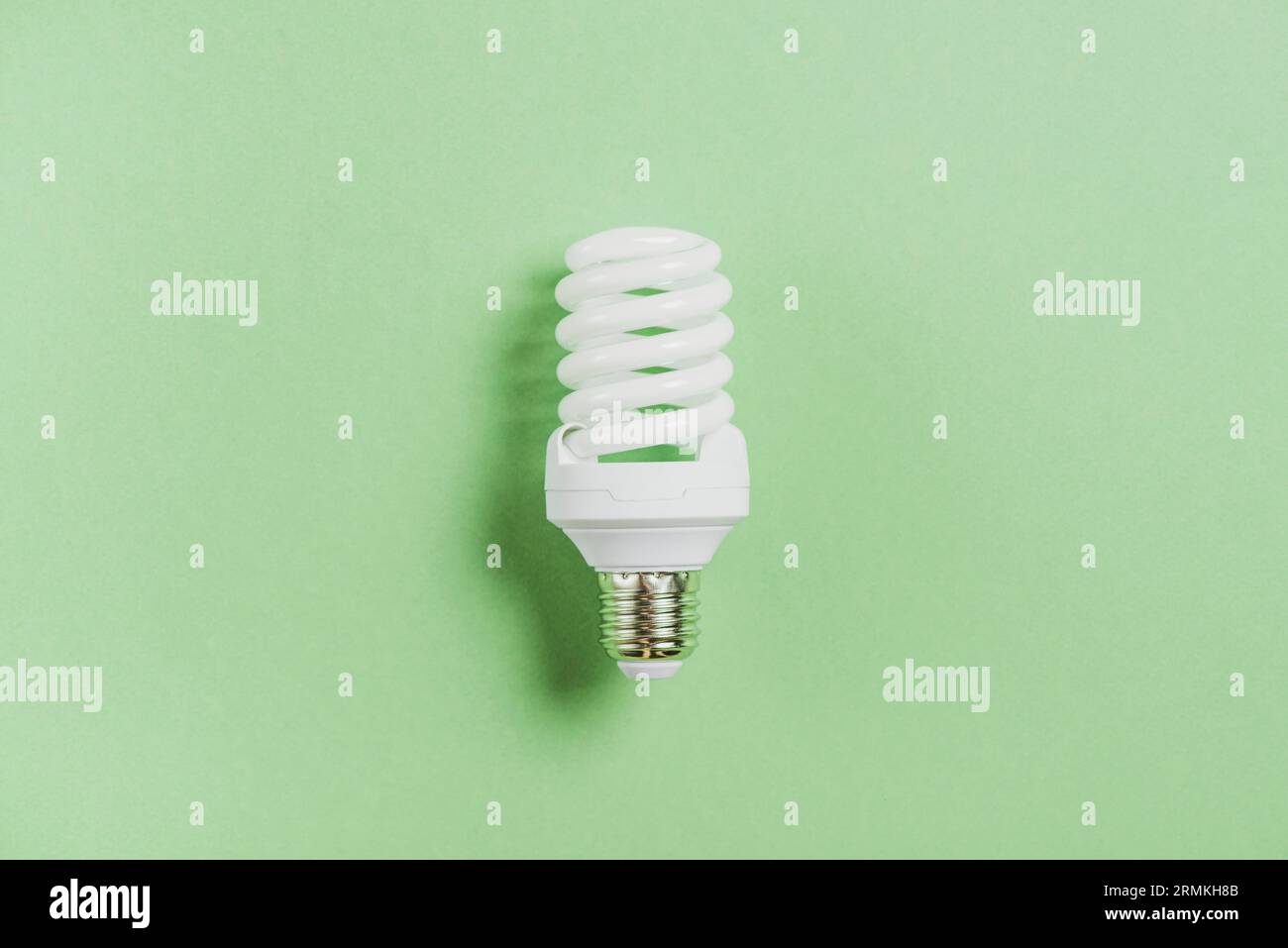 Compact fluorescent light bulb green background Stock Photo - Alamy