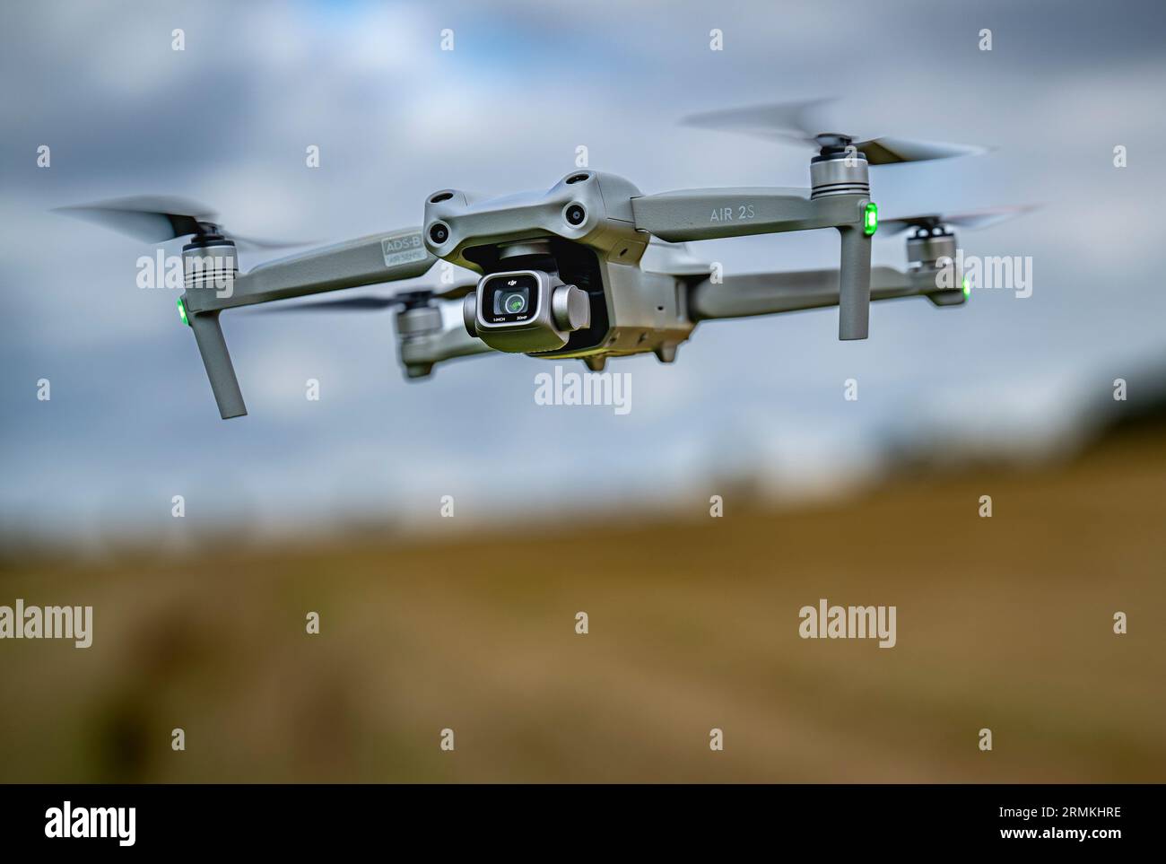 A DJI Air 2S Drone low to the ground as it hovers whist filming Stock Photo