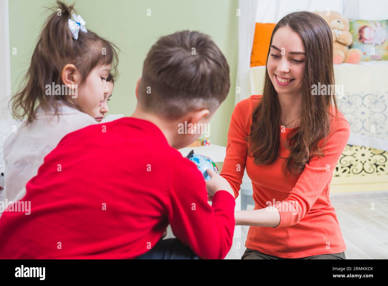 Teacher playing with kids Stock Photo
