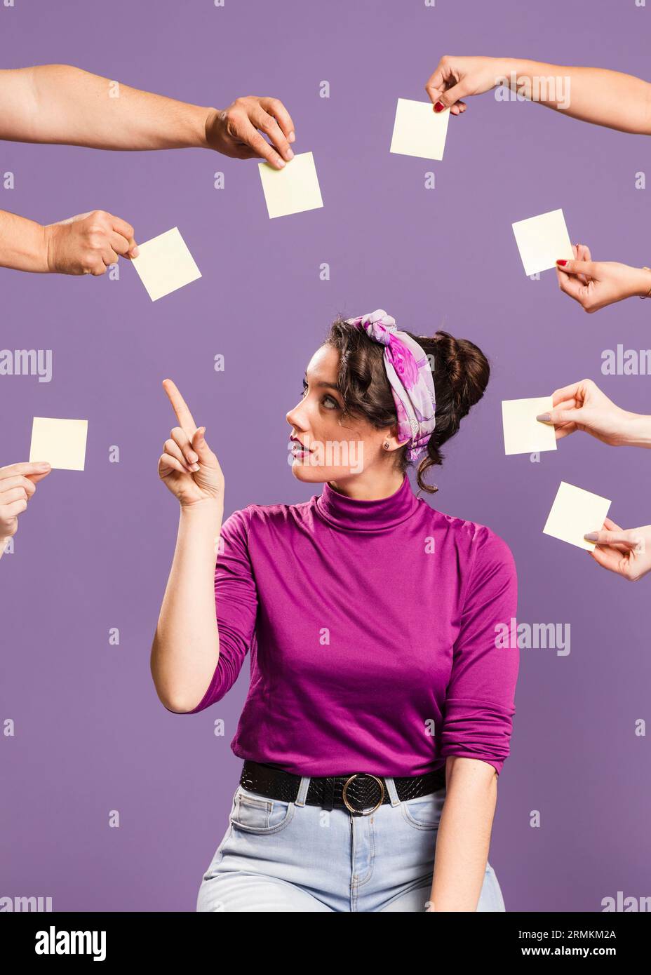 Woman surrounded by hands sticky notes picking empty note Stock Photo