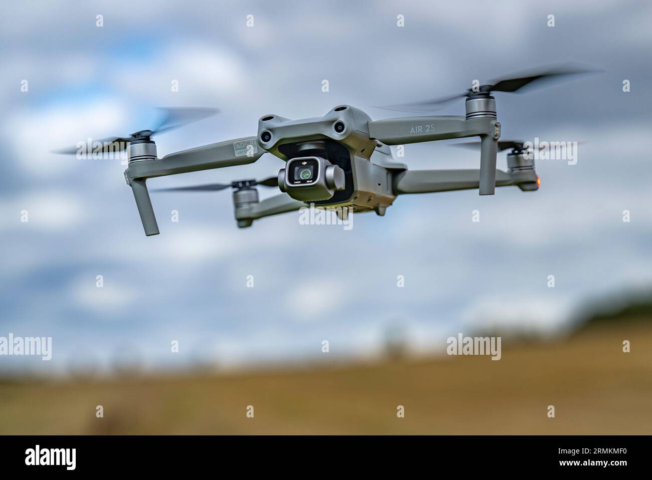 A DJI Air 2S Drone low to the ground as it hovers whist filming Stock Photo