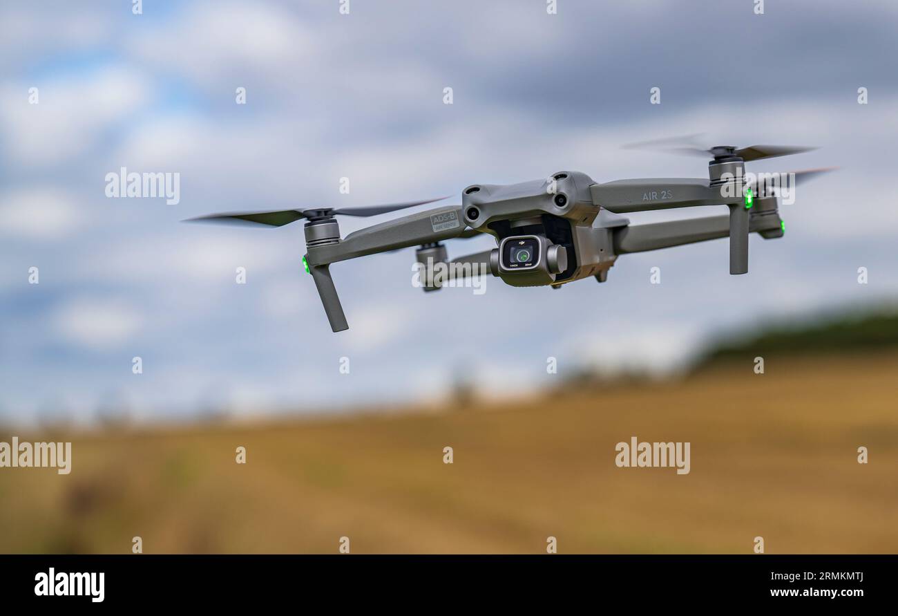 A DJI Air 2S Drone low to the ground as it hovers whist filming Stock Photo