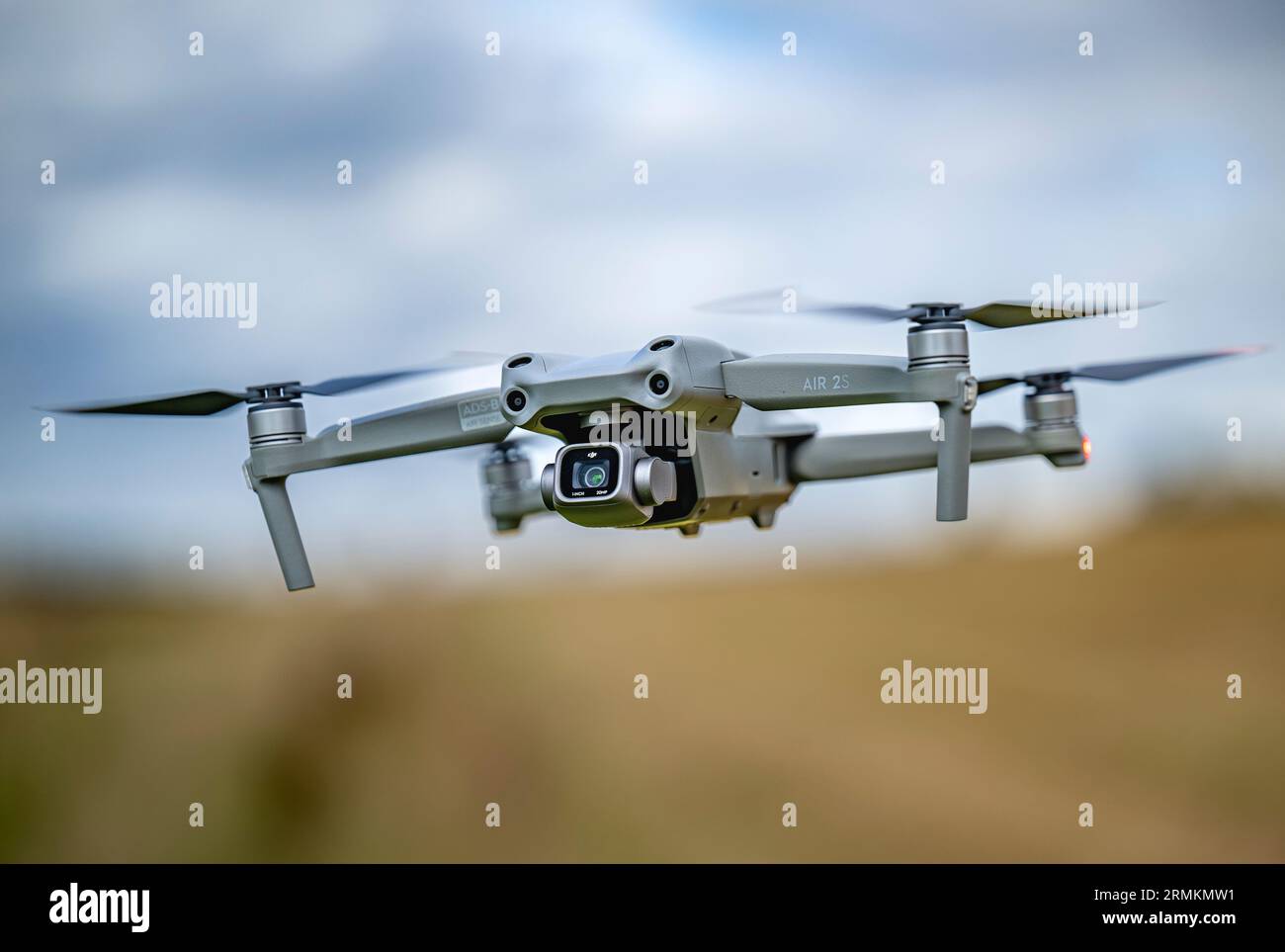 A DJI Air 2S Drone low to the ground as it hovers whist filming Stock Photo