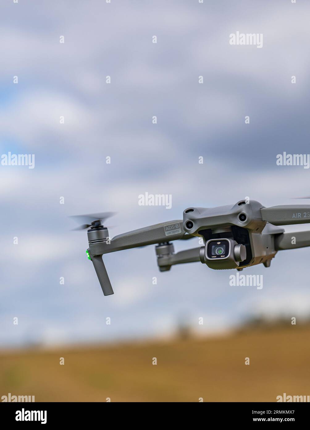 A DJI Air 2S Drone low to the ground as it hovers whist filming Stock Photo